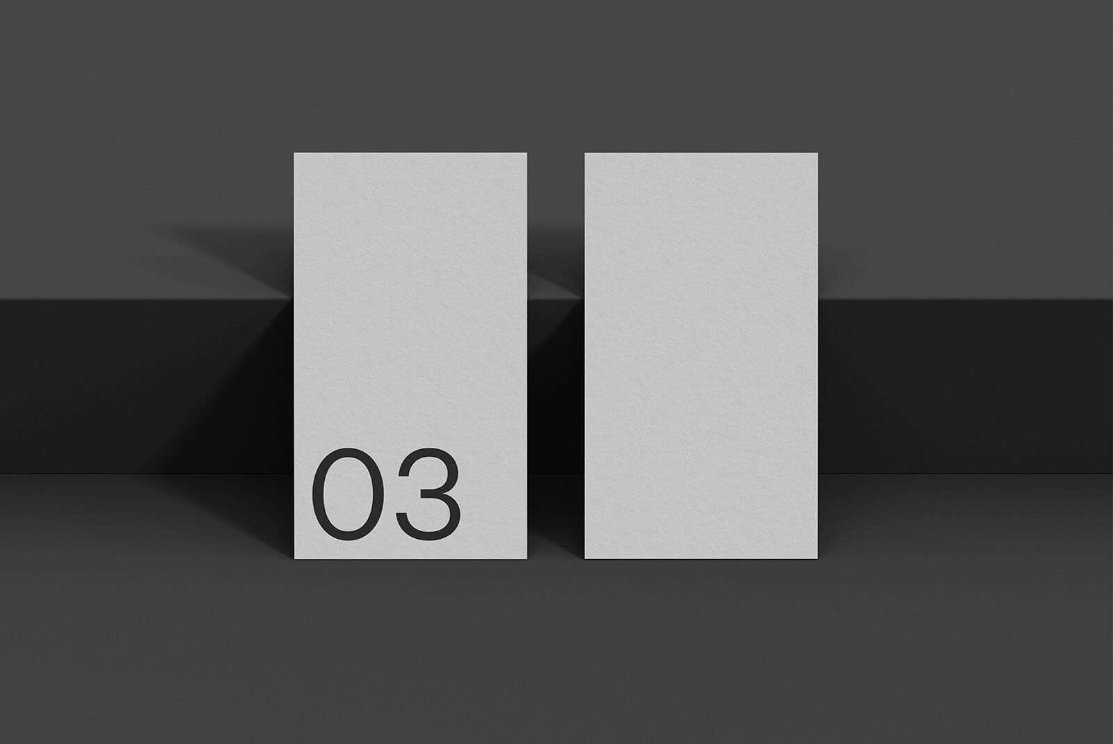 Minimalist business card print mockup with two cards on a dark background displaying number 03. Ideal for graphic designers showcasing print design projects.