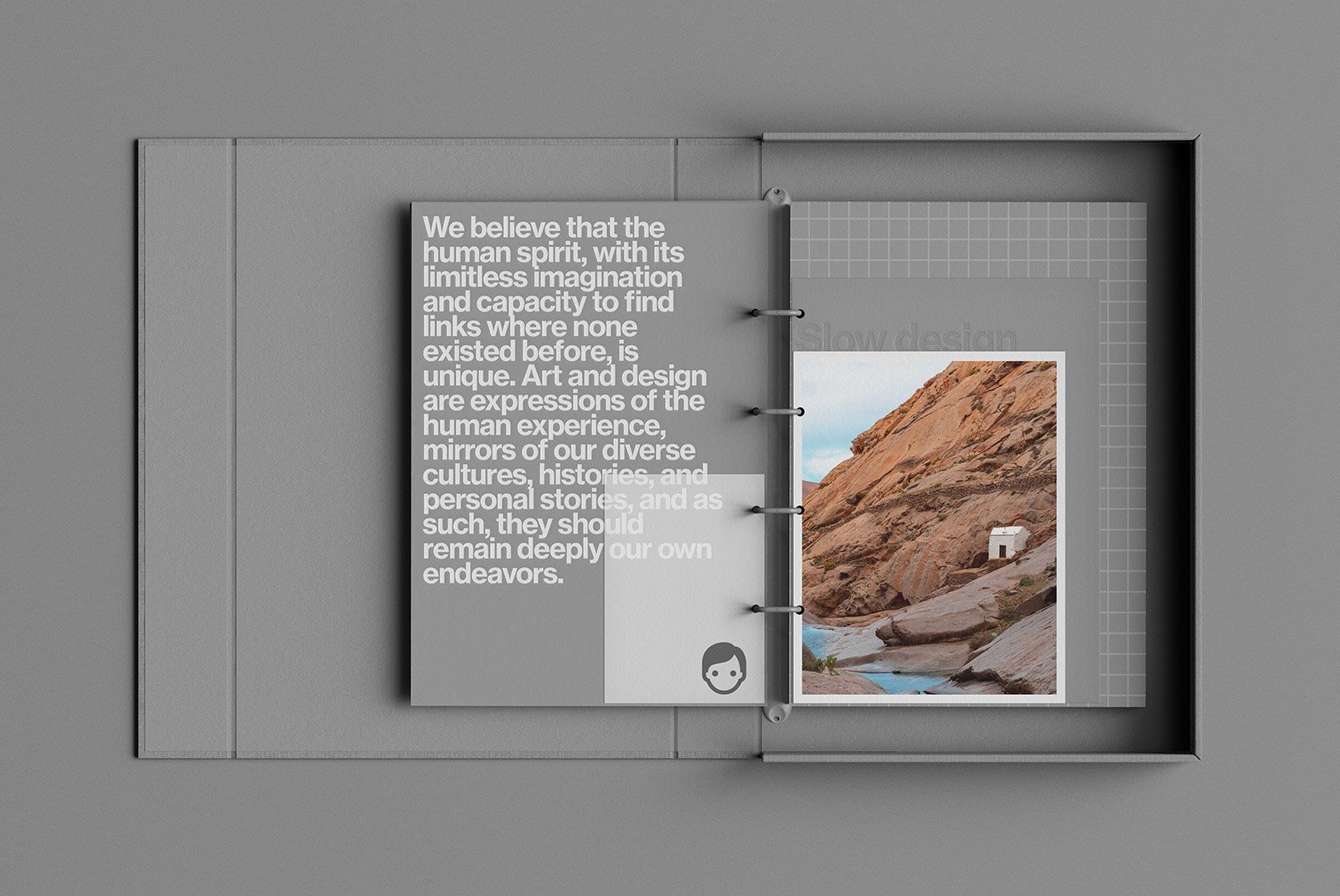 Open gray hardcover binder displaying design inspiration with text and a photo of rocky landscape suitable for graphic designers in print mockups category.