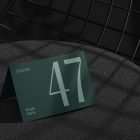 Green table card mockup featuring the number 47 set against a dark textured background perfect for graphic designers seeking print mockups and branding displays.