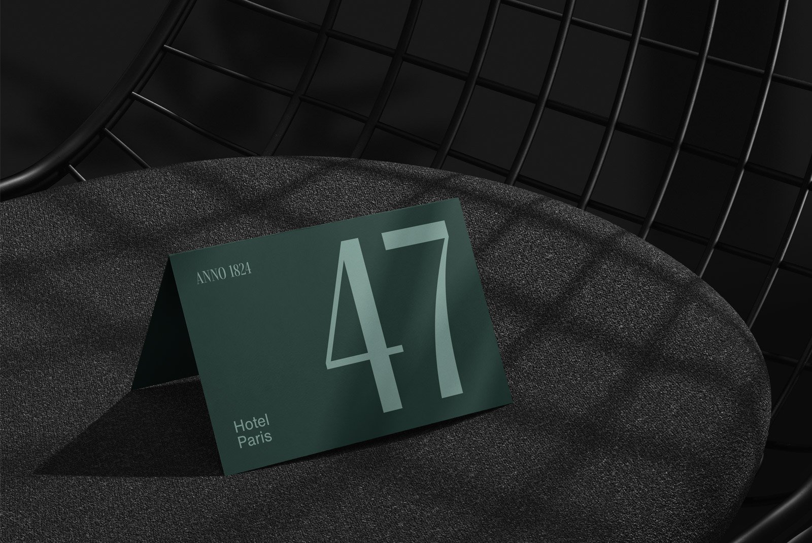 Green table card mockup featuring the number 47 set against a dark textured background perfect for graphic designers seeking print mockups and branding displays.