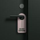 Do not disturb door hanger on black door handle mockup. Ideal for print and packaging design. Simple and modern style for graphic designers.