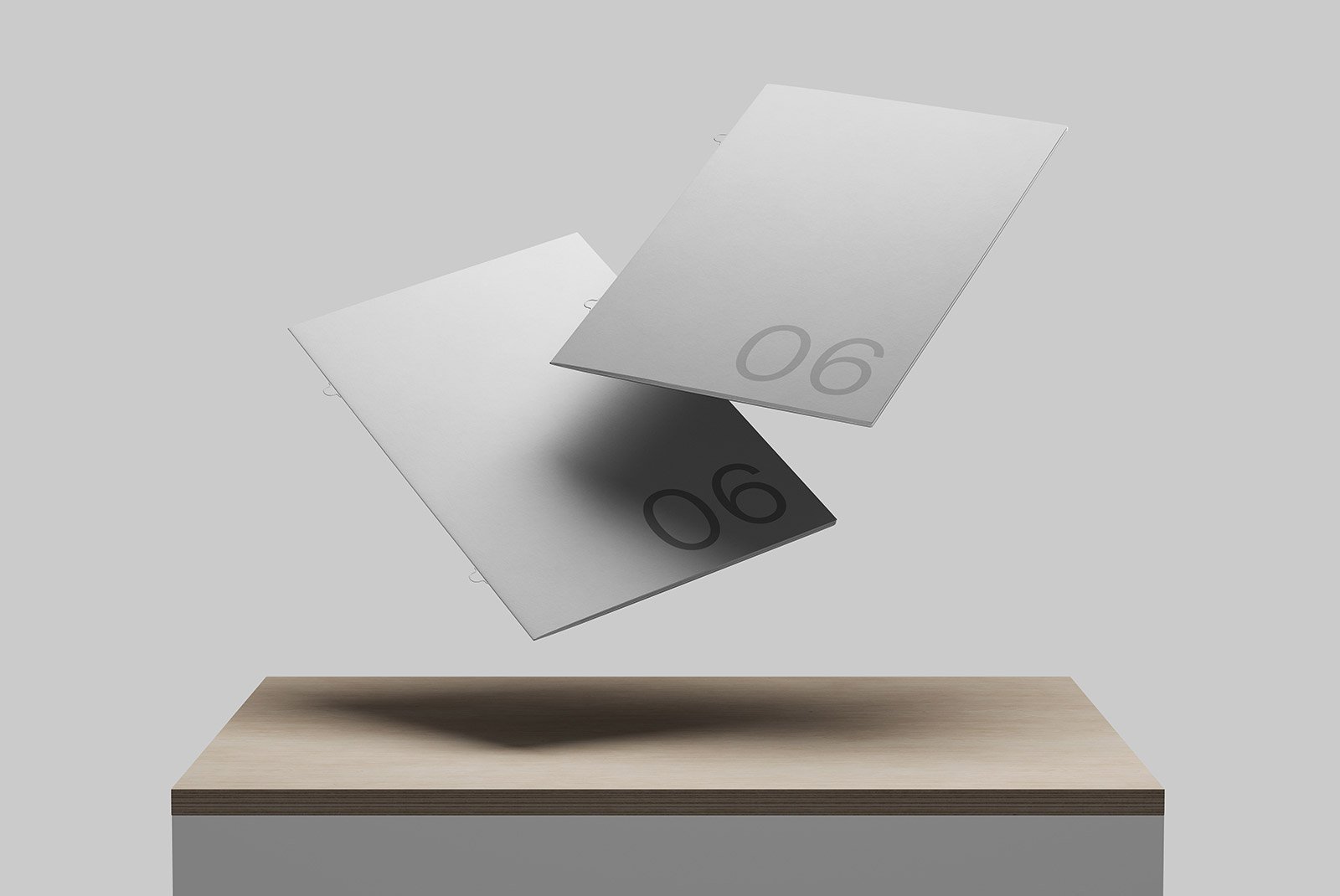 Floating sheet mockups with minimalistic number 06 design, ideal for graphic designers creating print mockups. Perfect for showcasing layouts or cover designs.