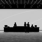 Silhouette of people at a modern reception desk with computers. Ideal for tech mockups, graphics, and photoshop effects. Minimalist, professional setting.