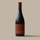 Wine bottle packaging mockup with minimalistic brown label and black top standing on neutral background. Ideal for graphic design, packaging mockups, and branding.