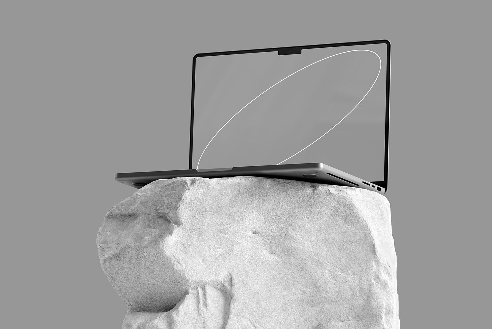 Minimalist laptop tech mockup on a rock with a grey background, ideal for showcasing digital designs, graphic assets, and tech product presentations.