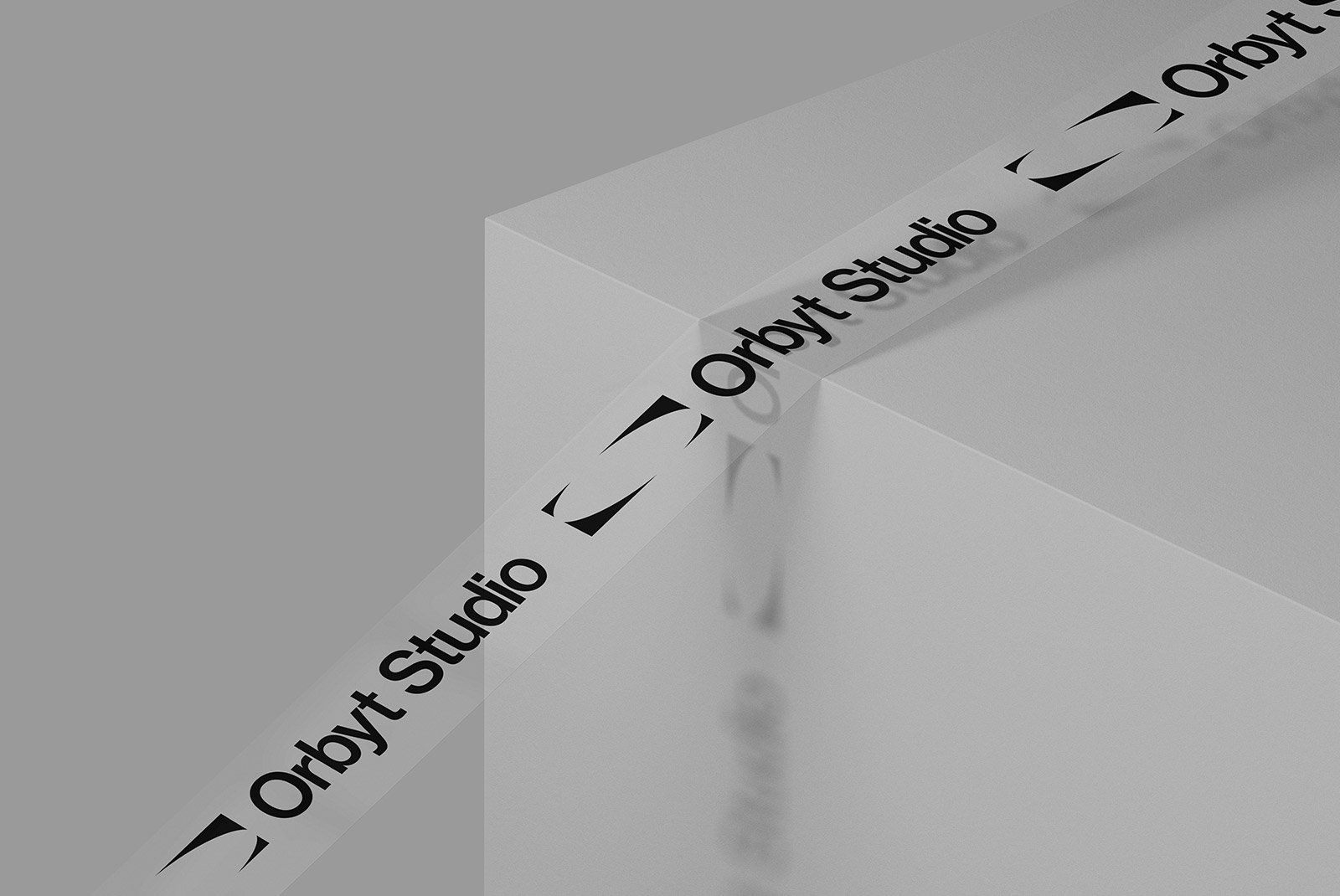 Minimalist packaging mockup featuring branded tape labeled Orbyt Studio wrapped around a sleek white box, suitable for graphic designers.