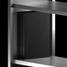 Black hardcover book on a metallic shelf. Subtle minimalist design suitable for Product Mockups, graphic design resources, and print packaging mockups.