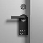 Minimalist door handle with a black tag labeled 01. Ideal for product mockups especially in the Packaging Mockups and Branding Mockups categories.