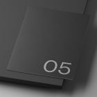 Black minimalistic booklet with the number 05 on the cover suitable for print mockups from a digital assets store for graphic designers.