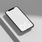 Minimalist smartphone mockup with sleek design placed on a surface perfect for showcasing digital tech assets available for graphic designers and digital artists.