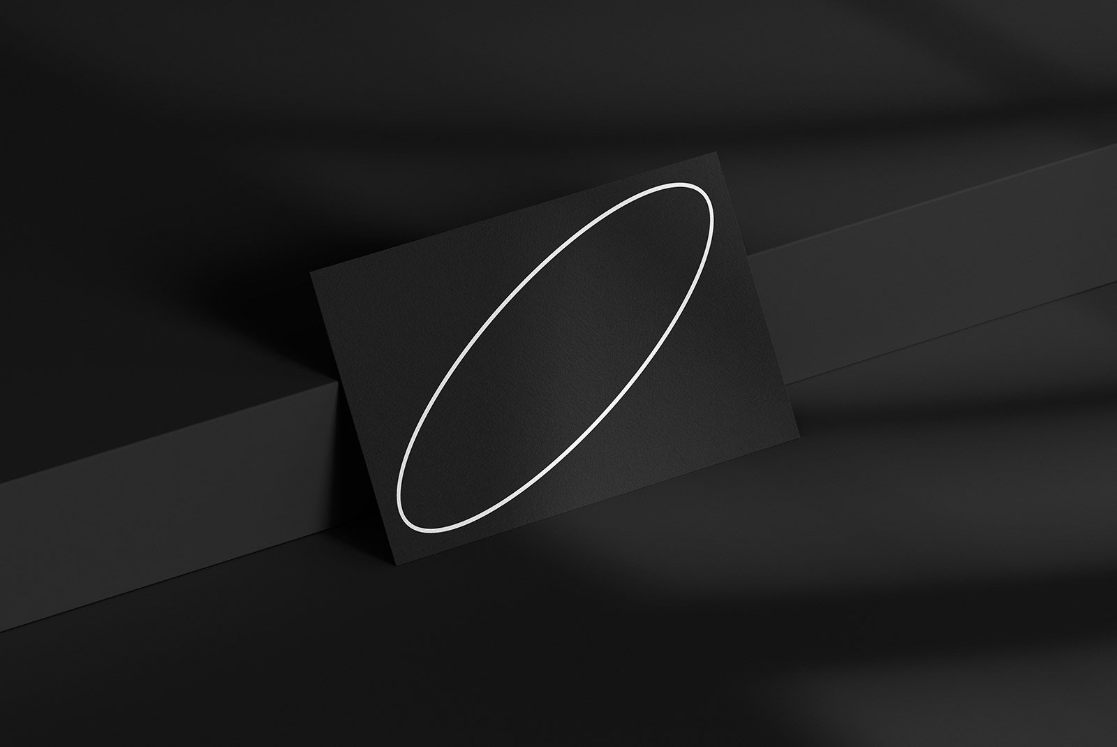Minimalistic business card design mockup with a white oval outline on a black background. Ideal for graphic designers and branding presentations.