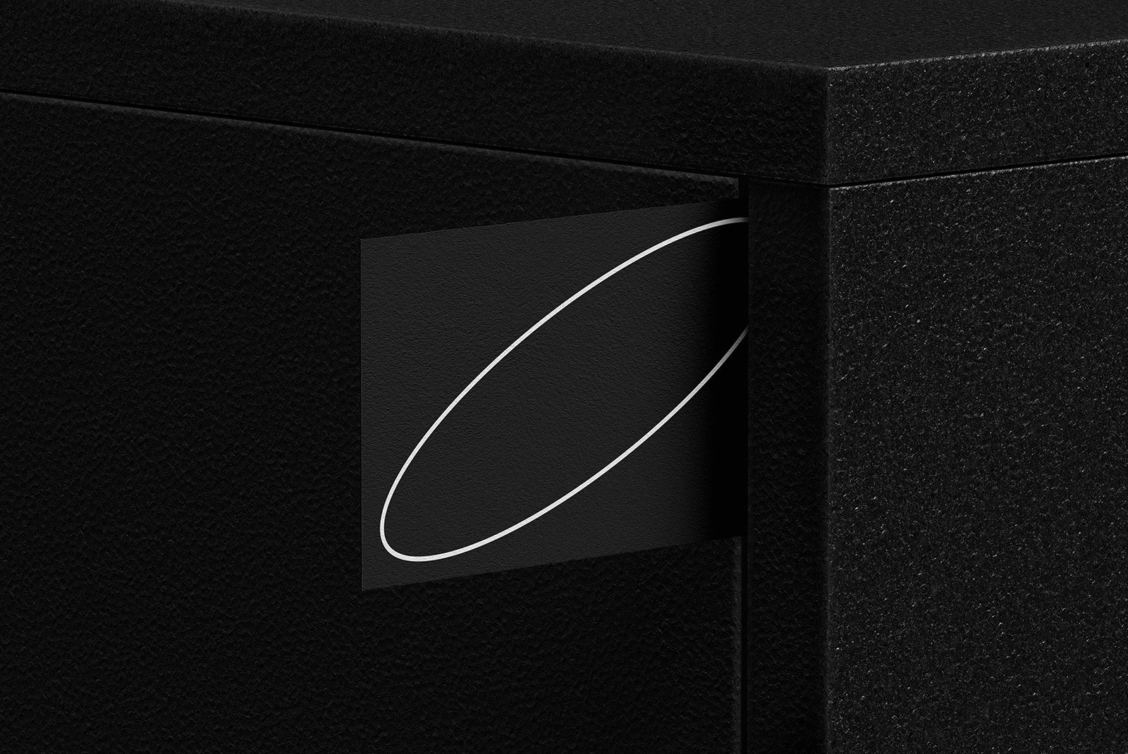Black textured surface showcasing an abstract graphic design mockup on a rectangular object, ideal for graphic designers seeking minimalistic design assets.