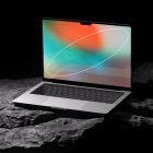 Laptop mockup for tech designs, featuring a sleek screen with abstract background placed on rocky surface. Ideal for graphic designers showcasing digital assets.