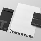 Minimalist stationery mockup with black and white branding, including an envelope, letterhead, and business cards. Ideal for graphic design and print mockups.