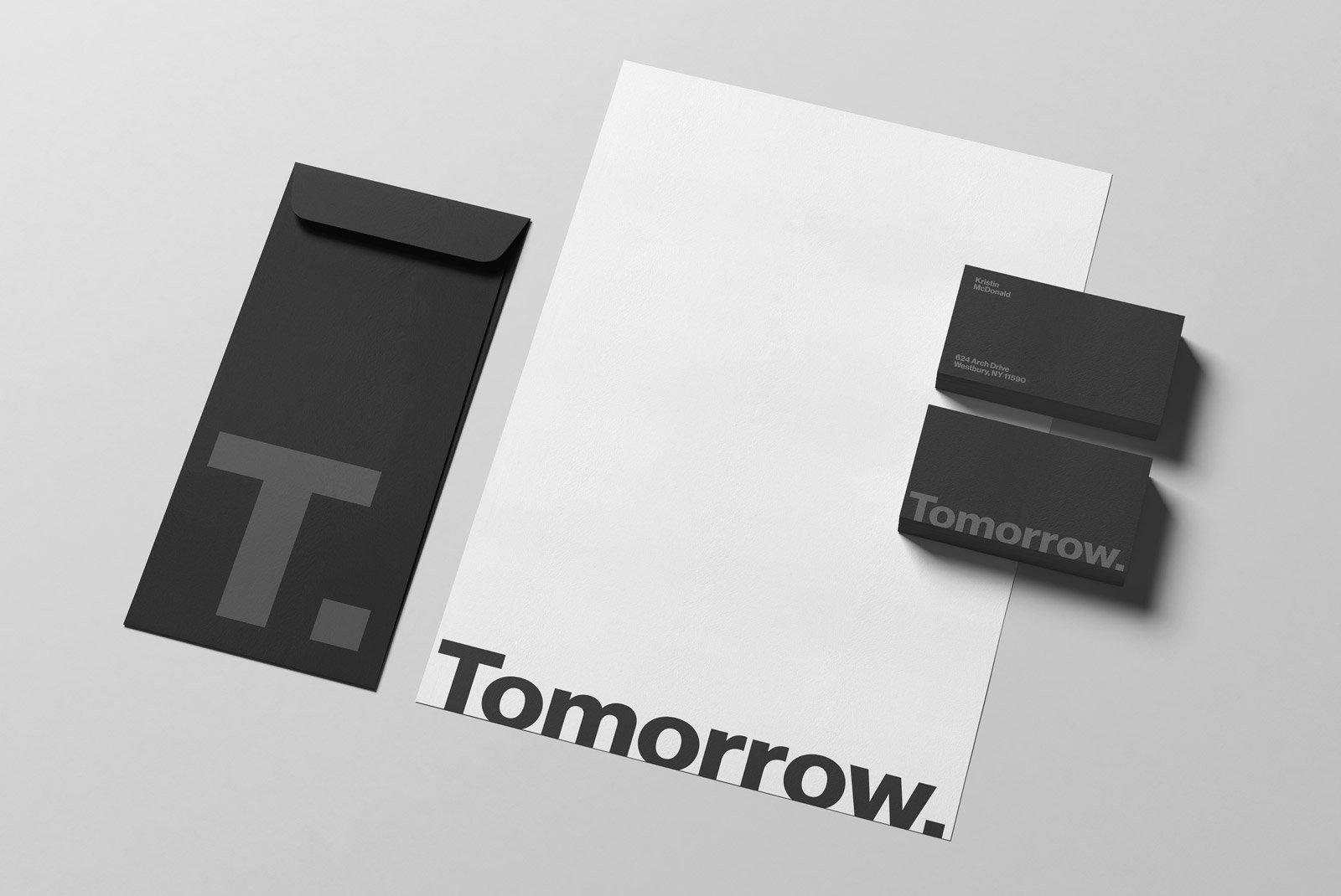 Minimalist stationery mockup with black and white branding, including an envelope, letterhead, and business cards. Ideal for graphic design and print mockups.