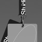 Lanyard badge mockup template for graphic designers featuring black and grey card designs on a secure clip against a dark background perfect for branding.