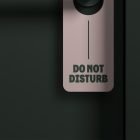 Do not disturb door hanger mockup on a black background ideal for graphic designers creating print mockups door tags and signage designs for hotels and offices.