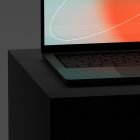Laptop mockup with a colorful gradient screen displayed on a dark podium perfect for showcasing tech designs to graphic designers looking for tech mockups