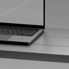Partial view of sleek laptop on a gray surface ideal for tech mockups graphic design digital assets and realistic product presentations for designers.