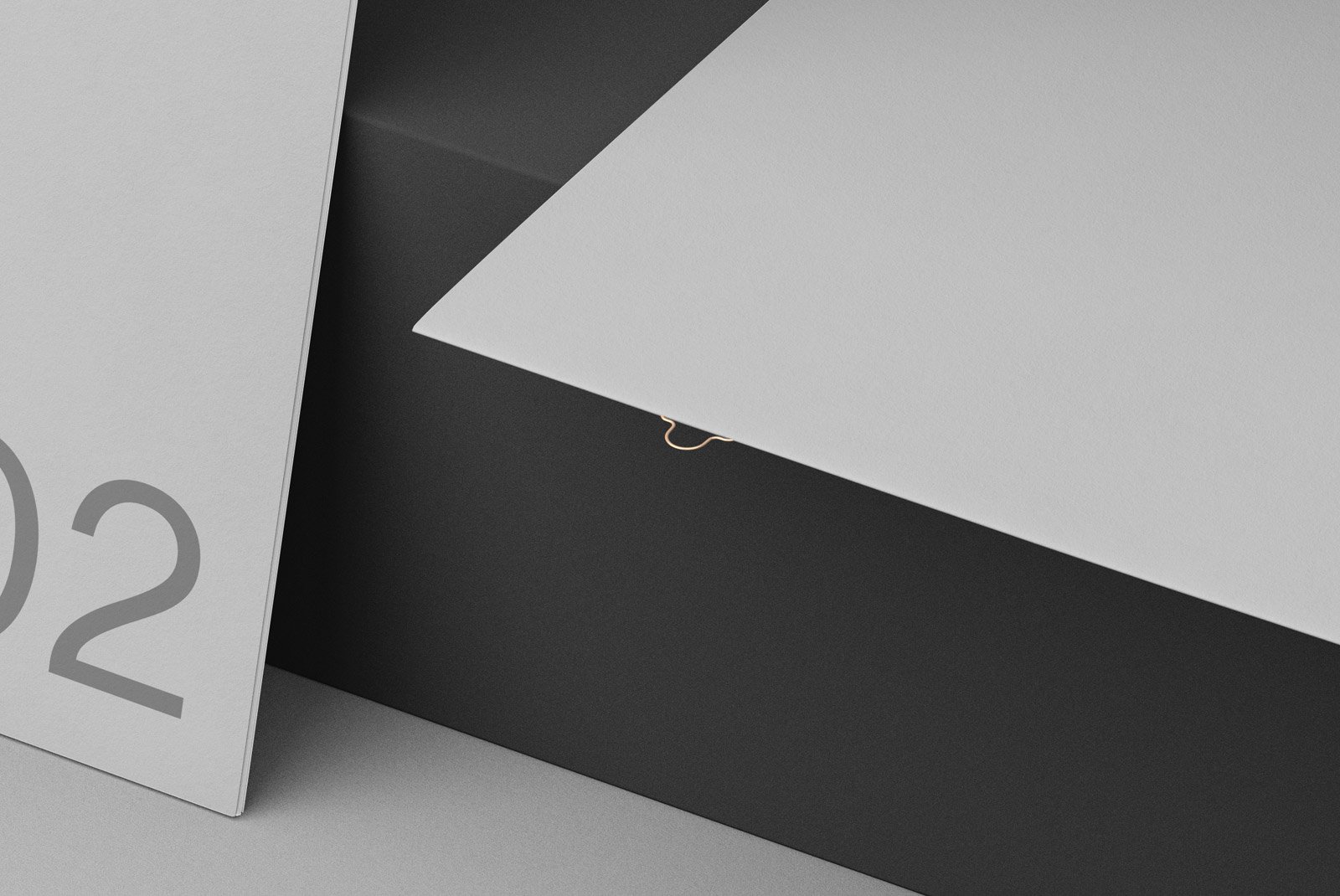 Close-up view of grayscale print mockup displaying minimalistic design with subtle shadows suitable for graphic designers and advertising professionals