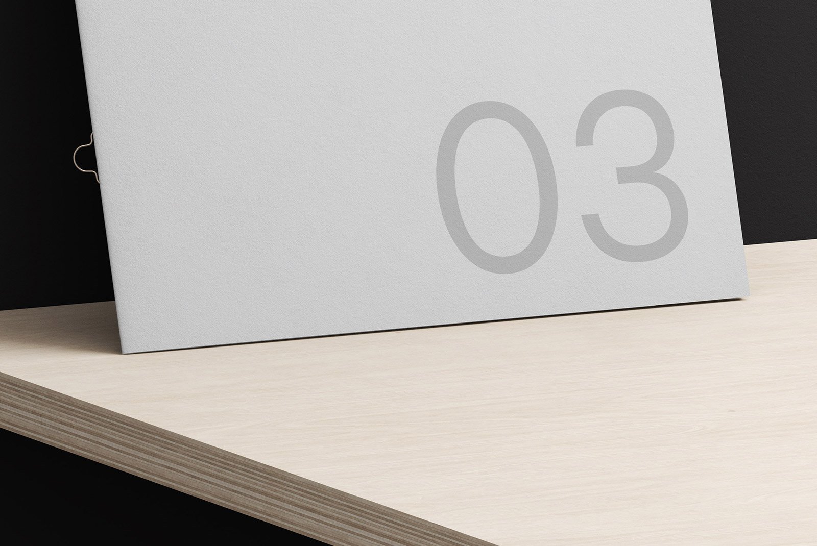 Minimalistic white brochure on wooden surface with number 03. Ideal for brochure mockups, print design, and graphic design resources for designers.