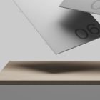 Grey cards with the number 06 hover above a wooden surface. Suitable for print mockups and graphic design projects. Ideal for graphic designers seeking clean imagery.