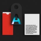 Minimalist design mockup featuring a red sleeve, black tag with iridescent A and a white card with embossed text. Ideal for packaging mockups and graphic design.