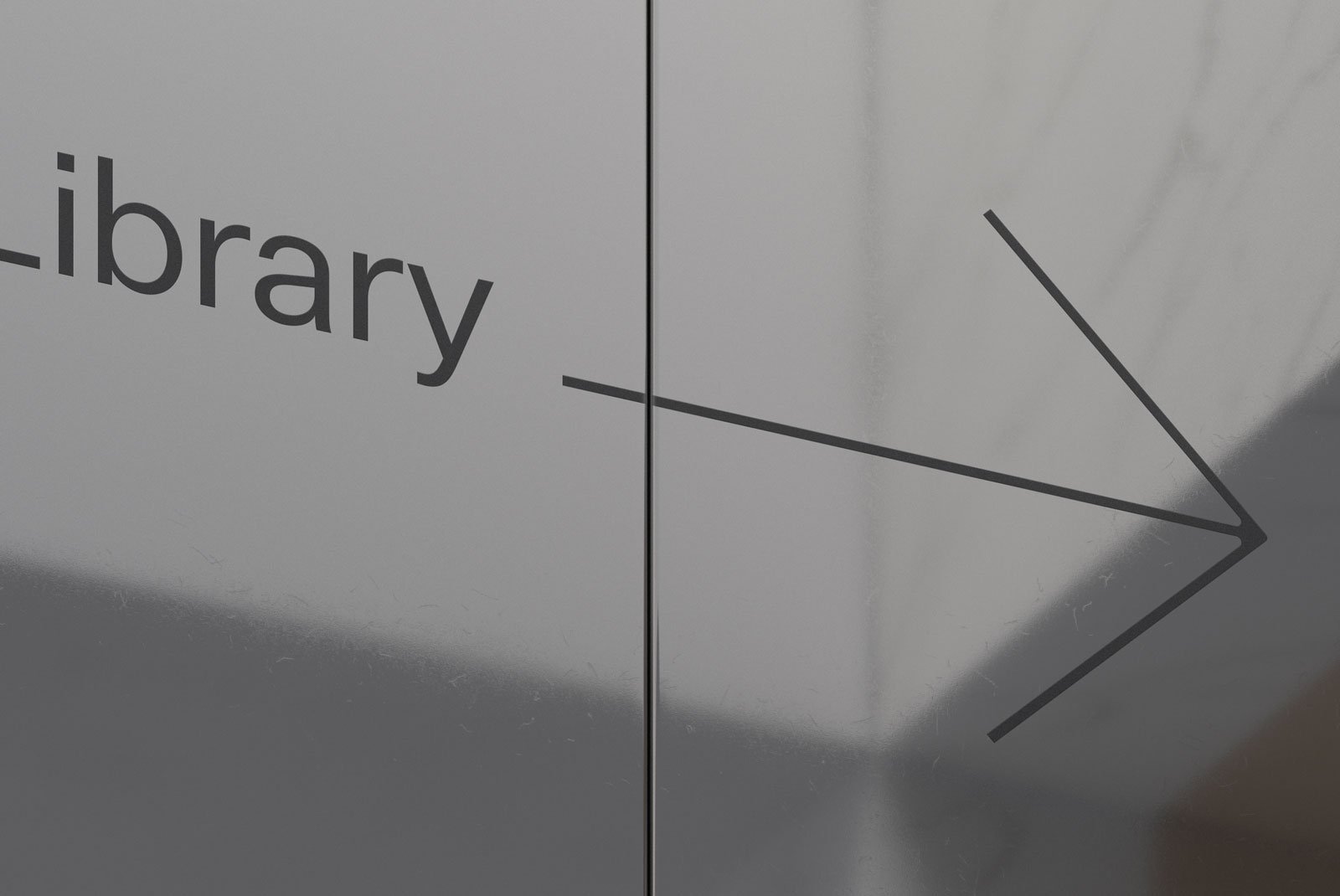 Directional sign pointing to a library in a modern style showcasing typography design suitable for graphics and print mockup references for graphic designers.