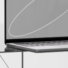 Tech mockup of a sleek laptop on a glass surface for graphic designers showcasing minimalistic design. Ideal for web design presentations, UI layouts, branding.