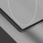 Top view of sleek tablet mockup partially visible on two-tone background. Ideal for tech mockups, product presentations, and design projects.