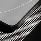 Close-up of a sleek tech device on a perforated metal surface suitable for tech mockups and digital assets for graphic designers.