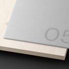 Minimalistic grey print mockup on a wooden surface displaying the number 05 designed for graphic designers and digital assets SEO mockup resources printable