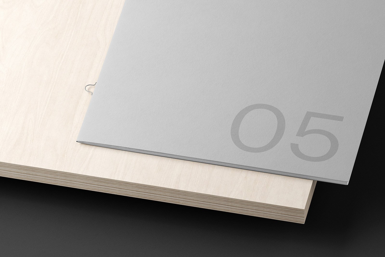 Minimalistic grey print mockup on a wooden surface displaying the number 05 designed for graphic designers and digital assets SEO mockup resources printable