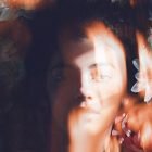 Creative double exposure effect showing a person's face blended with soft floral elements, suitable for graphic design, Photoshop effects, digital artwork use.