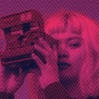 Vibrant photo effect of a person with a camera, using pink and purple tones. Perfect for graphic designers seeking creative ideas for print mockups, graphics.