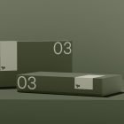 Minimalist packaging mockup featuring two rectangular boxes labeled 03 on a green background. Ideal for showcasing graphic design, packaging design.