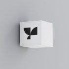 Wall-mounted signage mockup featuring a minimalist black and white geometric logo on a cube, ideal for graphic designers seeking branding design visuals.