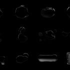 Black liquid splash elements on dark background for graphic design pack. Suitable for Photoshop effects, graphics, and tech mockups. High-quality assets.