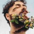 Artistic collage of bearded man with flowers emerging from beard creative graphics for digital designers unique Photoshop effects perfect for design projects.