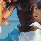 Close-up of a person wearing goggles with torn paper collage effect. Suitable for Photoshop effects category. Keywords: Photoshop, collage, close-up, graphics.
