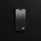 Black smartphone connected by a charging cable on black background perfect for tech mockups designers digital assets sleek minimalistic modern design
