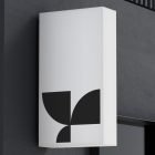 Modern building exterior with white vertical billboard mockup displaying black geometric design ideal for graphic designers seeking professional branding visuals.