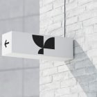 Outdoor signage mockup on a white brick wall with modern design and arrow, ideal for graphic designers seeking billboard and billboard mockups for branding visuals.