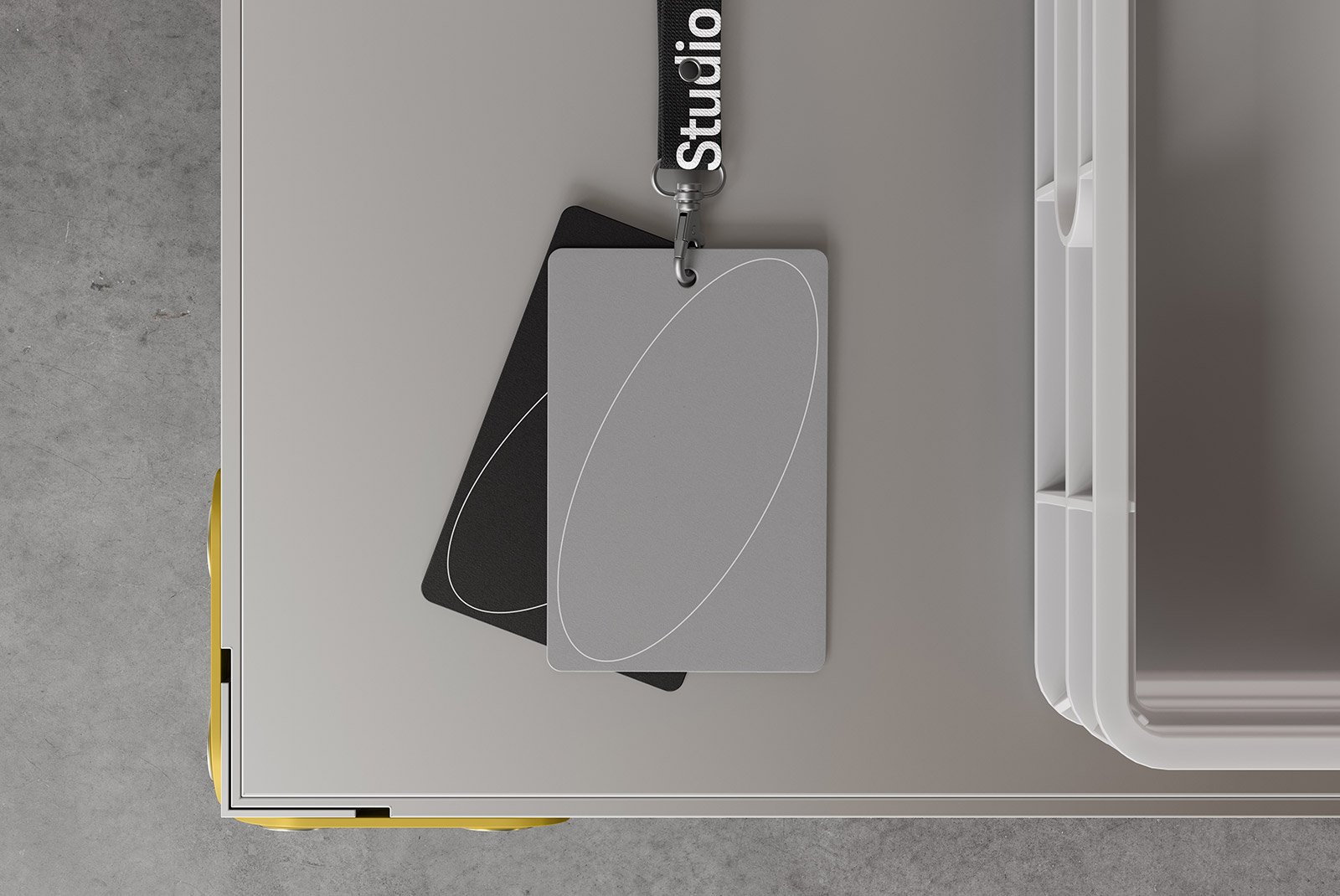 Top view of a modern ID card mockup with a lanyard on a grey textured surface ideal for graphic designers and print mockup projects.