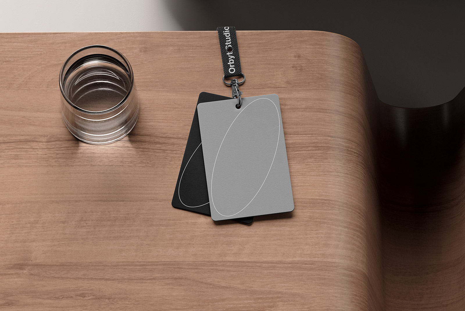 Business card mockups on a wooden desk with a glass of water nearby perfect for graphic designers and digital asset stores showcasing print mockups.