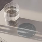 Glass tumbler on a modern desk with round coaster concept. Perfect for print, packaging mockups, and graphic designs for product showcasing.