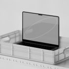 Laptop on metal shelf in plastic crate mockup. Perfect for showcasing tech mockups and product designs aimed at graphic designers. High-resolution display.