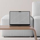 Laptop on modern table in minimalistic setting, showcasing tech mockup ideal for graphic designers, digital assets, design resources, mockup templates.