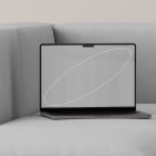 Laptop mockup on gray sofa with sleek design and minimalist background ideal for tech mockups graphic designers digital assets and design presentations.