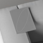 Minimalist book cover mockup laying on a gray couch perfect for print and graphic designers showcasing branding and book cover designs in a realistic setting